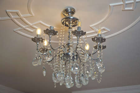 Chandelier Lamp beautiful luxury expensive chandelier hanging under ceiling . The lamp in the beautiful room .Brass chandelier with crystal. Chandelier ceiling lightsの写真素材