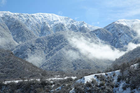 It snowed in the village. The leaves of the trees fell on the mountain. It snowed in the mountains and in the village. Bash Dashagil village of Oguz region.Blue skyの写真素材