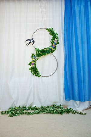 Number eight made of small green leaves and wooden letters "March" concept for international womens day 8 march white background. Decor for a photo shootの写真素材