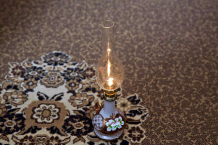 Vintage kerosene oil lantern lamp burning with a soft glow light in an antique rustic country barn with . At the wedding, the father spins his daughter three times on the lamp.の写真素材