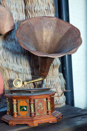 Azerbaijan Baku.19.08.2021 . Old record player against ancient wooden wall. Antique gramophone with retro plate produces pleasant sounds or music. Vinyl record set Stereo system. sound technology conceptの写真素材