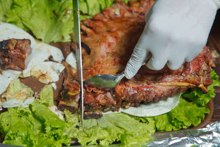 Many Cooking Traditional Azerbaijan asting lamb barbecues.Roasted meat over an open fire, cooked in a special way.Barbecue is prepared of lamb or sheep meat and processed by slasher. chops the sheep.の写真素材