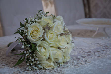 Flowers bouquet. Beautiful roses, gerbera flowers, daisy flowers . bride is handing a beautiful wedding bouquetの写真素材