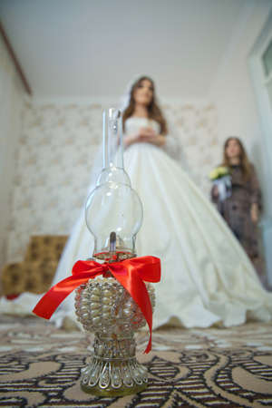 Vintage kerosene oil lantern lamp burning with a soft glow light in an antique rustic country barn with . At the wedding, the father spins his daughter three times on the lamp.の写真素材