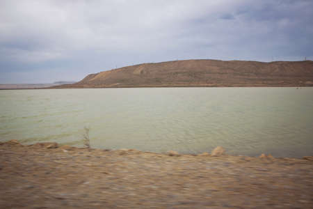 Green lake and bare mountain . walking in the dune and water landscape at the wetlands outsideの写真素材