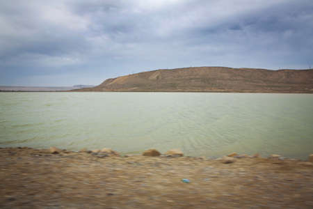 Green lake and bare mountain . walking in the dune and water landscape at the wetlands outsideの写真素材