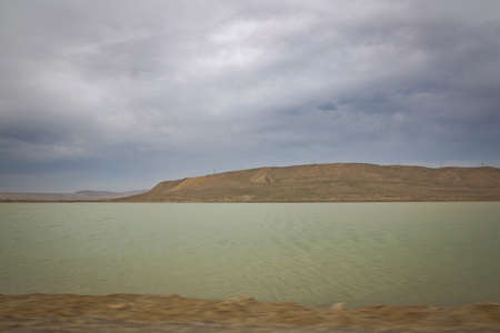 Green lake and bare mountain . walking in the dune and water landscape at the wetlands outsideの写真素材
