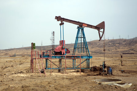 Oil and gas drilling rig onshore dessert with dramatic cloudscape . Land oil drilling rig blue sky .Land rig during the drilling operationの写真素材