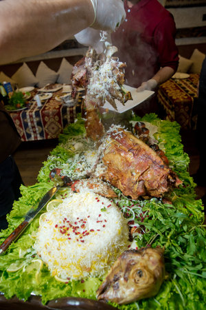 Barbecue is prepared of lamb or sheep meat and processed by slasher. pilaf . Pour the stuffing into a plate. Roasted meat over an open fire, cooked in a special way.の写真素材