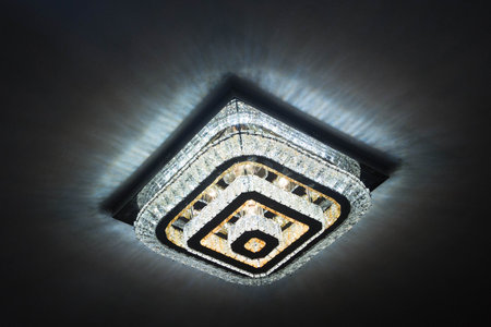 A big Crystal Chandelier with full of lights, Beautiful glass Chandeliers background. Sureal chandelier emitting magical light . Rectangular chandelier with remote control .の写真素材