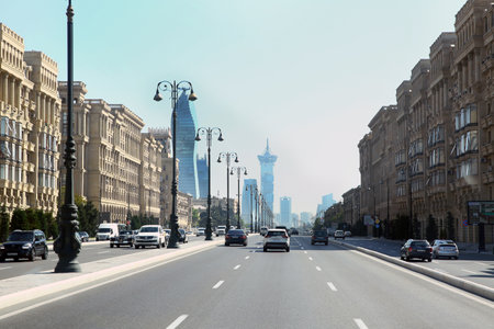 Azerbaijan Baku . 14. 05 .2021 . Heydar Aliyev Ave . Five-storey modern houses on the side of the asphalt road . Four-lane highway .のeditorial素材
