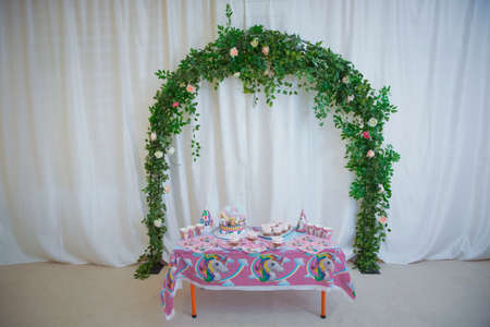 Baku Azerbaijan .26.06.2021. Arch with floral decorations . flower arch with flowers, branches and green leaves . design decoration elements with floral design . CandyBar Rainbow Baby Unicorn .の写真素材