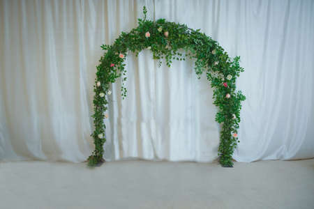 arch with floral decorations . flower arch with flowers, branches and green leaves . Beautiful wedding ceremony design decoration elements with floral designの写真素材