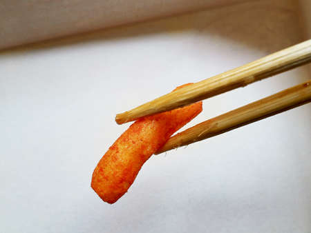 A snack clamped with chopsticksの写真素材