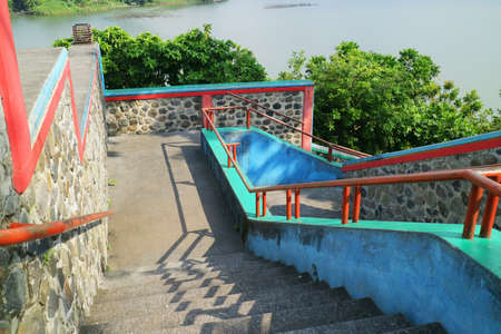 a long staircase descends and turns in a park photoの写真素材