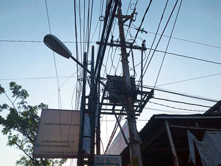 Semarang Indonesia July 24, 2021: many people install cables on electricity poles, so the poles become full of messy wires, on the st Tentara Pelajar, Semarangのeditorial素材