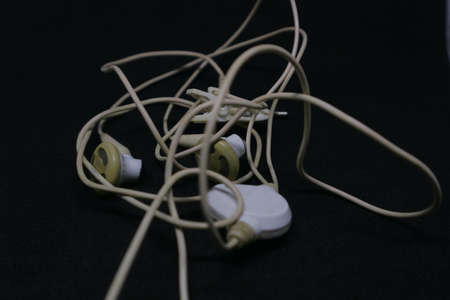 white color of earphone with messy cable photo