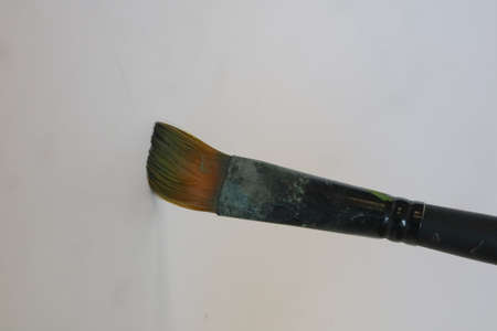 dirty old brush for painting on white isolated background photo