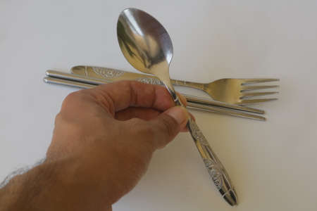 stainless fork and spoon on white isolated background photoの写真素材