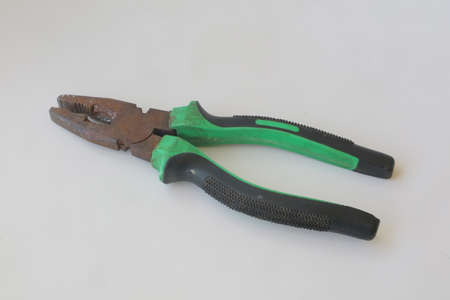 green iron pliers on white isolated background photo