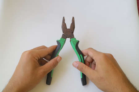 green iron pliers on white isolated background photoの写真素材