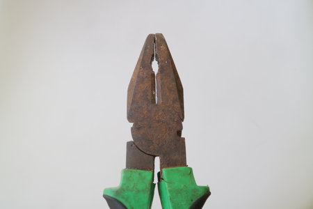 green iron pliers on white isolated background photoの写真素材