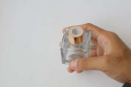 glass perfume bottle with gold cap on white isolated background