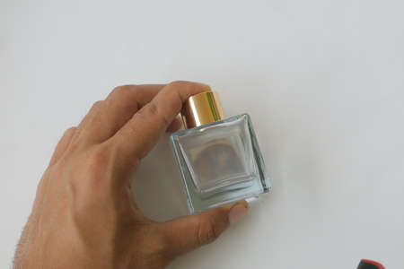 glass perfume bottle with gold cap on white isolated background