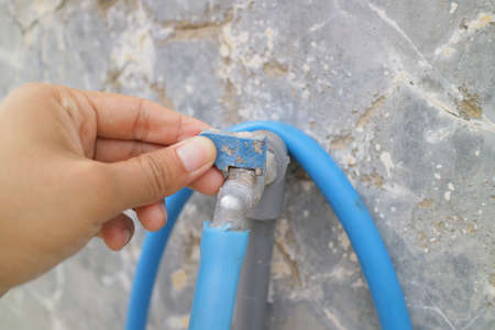 Semarang Indonesia november 22 2021: a photo of water faucet and hose in front of the house