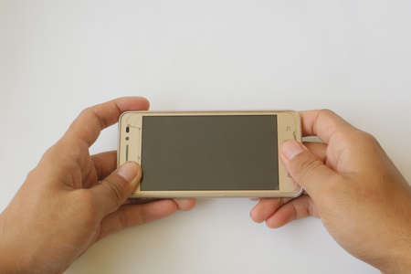 two hands holding brown smart phone photo