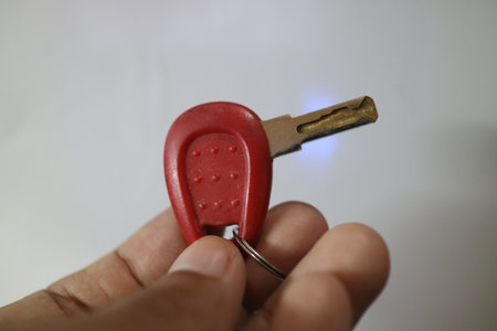 small red key on a white background photoの写真素材