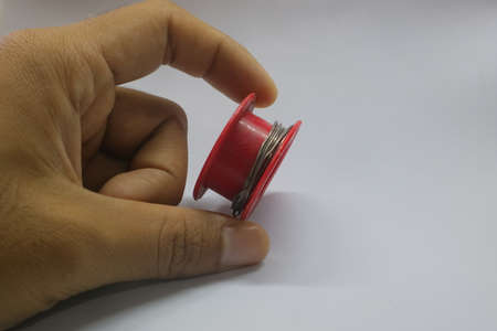 Red tenol for soldering on white isolated background photo