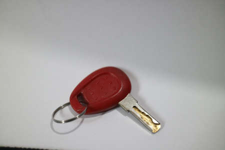 small red key on a white background photoの写真素材