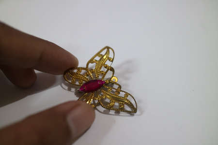 gold butterfly shaped clothing brooch photoの写真素材