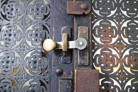 simple lock on scrap metal window photoの写真素材