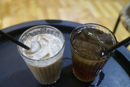 iced latte and fresh iced lemon in a glass photo