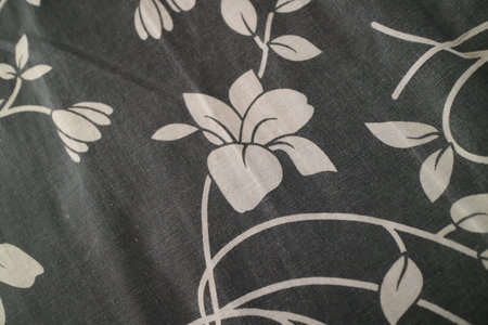 a photo of a black cloth with pictures of plants and flowers