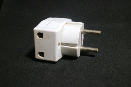 A photo of white electric socket with worn out condition