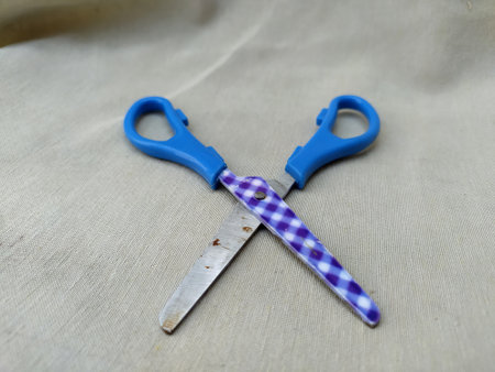 A photo of Medium sized paper scissors with light blue handlesの写真素材