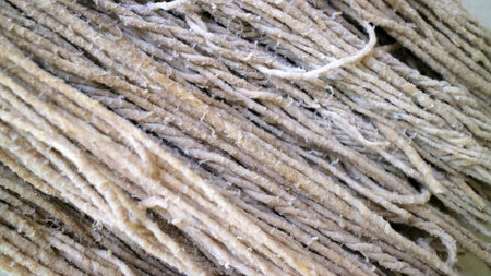 Detailed macro photo showing rough surface and natural texture of thick brown twisted fiber strands...