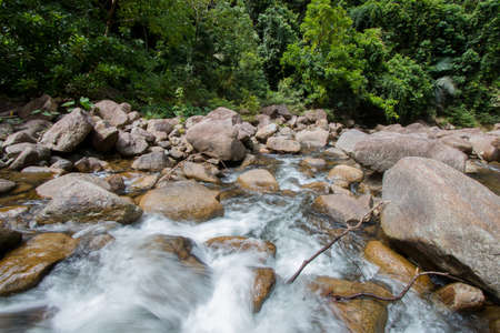Water Flows Through Rocks In a mountain stream at Phrom Lok Waterfall, Khao Luang National Park in...