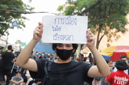 Bangkok, THAILAND - August 16, 2020: Protesters show text mean "Politics is not a joke." at Democracy Monument to protest against the government, demand for new constitution and thai monarchy reform.のeditorial素材