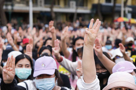 Bangkok, THAILAND - August 16, 2020: Protesters a three finger salute to show symbolic gestures at Democracy Monument to protest against the government, demand for new constitution and monarchy reform.のeditorial素材