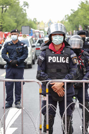 Bangkok, THAILAND - October 14, 2020: Police road block by bus, barrier and Razor Barbed Wire...