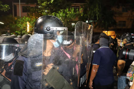 Bangkok, THAILAND - February 10, 2021: Protesters guard face the Riot police after disturbance...