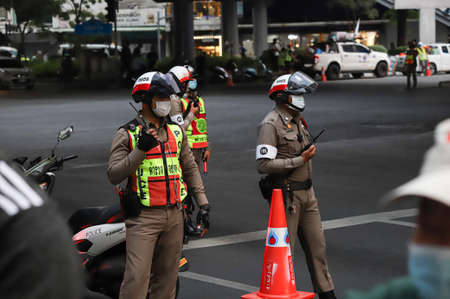 Bangkok, THAILAND - February 10, 2021: Traffic police facilitate traffic between pro-democracy protest at Pathumwan Intersection.のeditorial素材