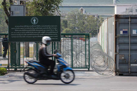 Bangkok, THAILAND - February 20, 2021: Thai Government barrier by container and Razor Barbed Wire to protect Restricted area from Pro-Democracy protests.のeditorial素材