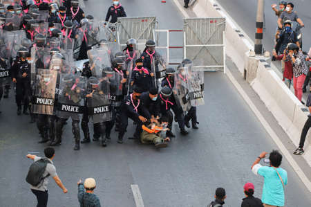 Bangkok, THAILAND - February 28, 2021: Riot police attack arrest protesters during Pro-democracy...