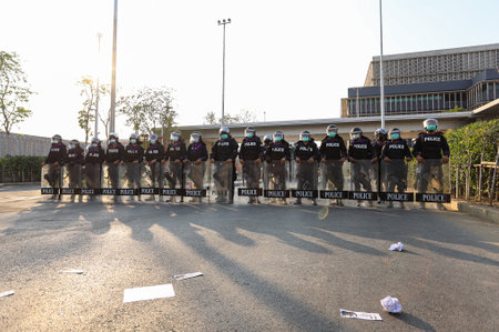Bangkok, THAILAND - February 20, 2021: Riot Police stand guard to protect Sappaya-Sapasathan from Pro-democracy protesters no-confidence motion outside the parliament.のeditorial素材