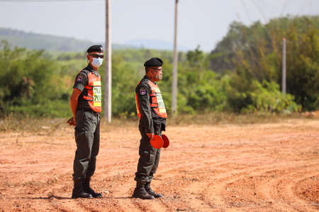 Nakhon Si Thammarat, THAILAND - March 4, 2021: Police marshaller standby Marshalling signals to Helicopter Take off at Field between Deputy Minister of Agriculture and Cooperatives inspection program.のeditorial素材